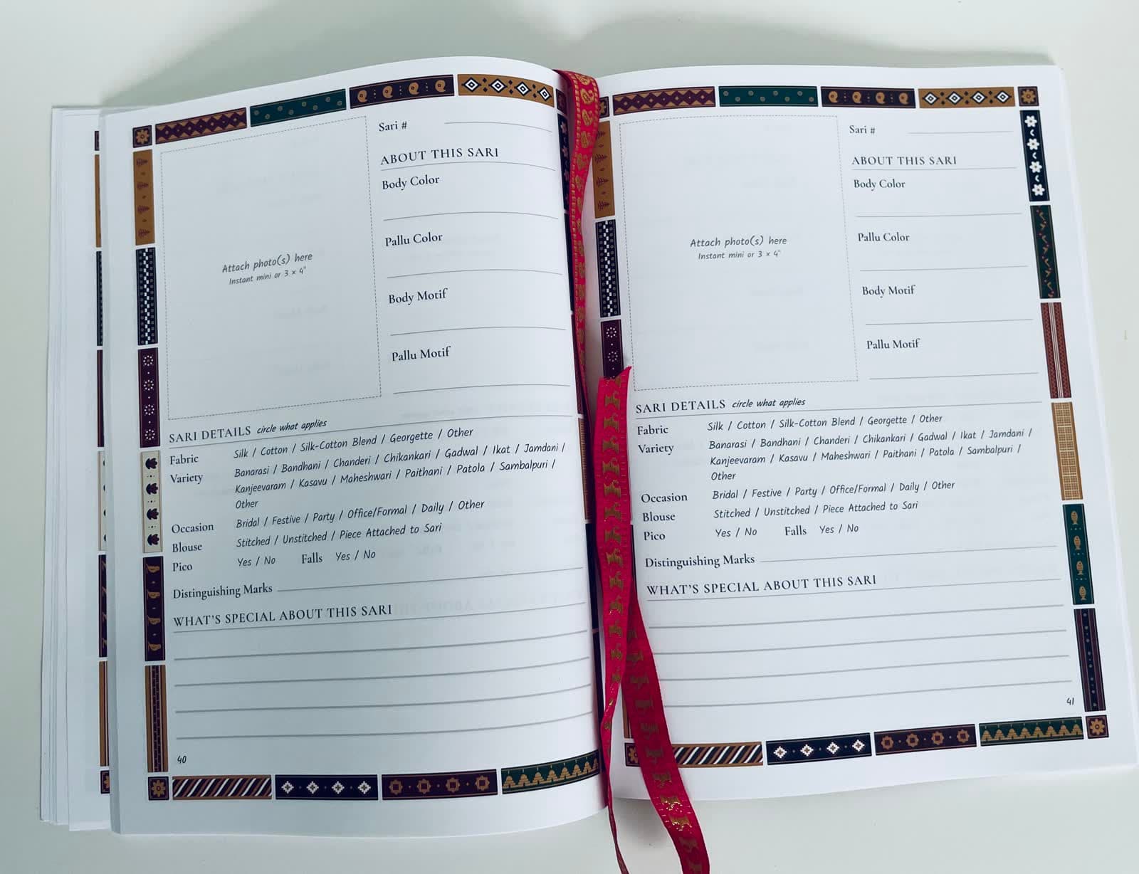 A blank spread showing two empty sari pages with the motif borders