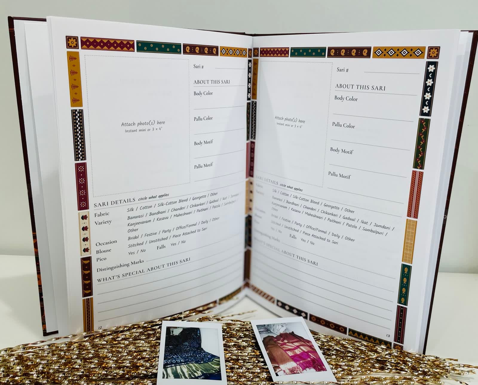 The book standing open on a blank spread, with two instant prints in front of it